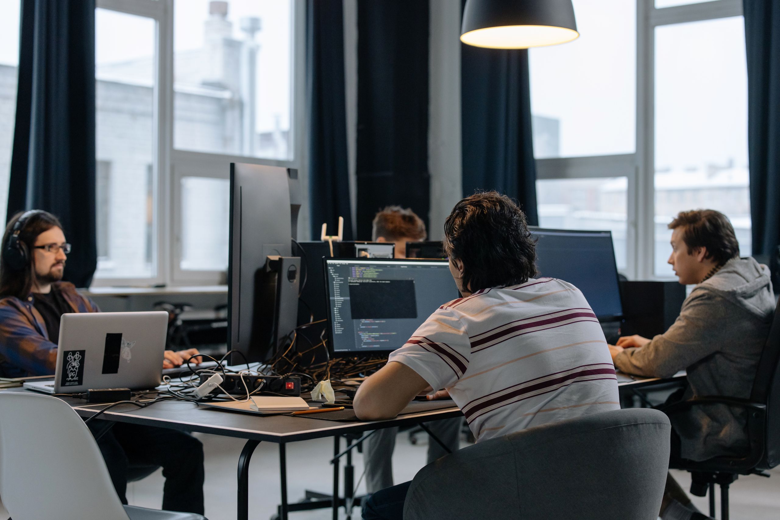 Resourcing 11 Team of developers working together on computers in a modern tech office.